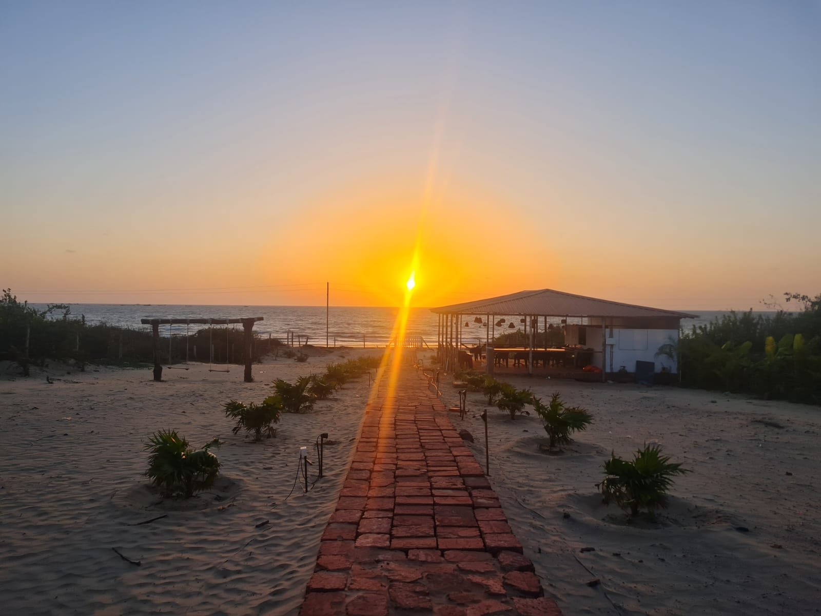 Sunset at Tarkarli Beach Devbag Malvan Sindhudurg with fishing boats and palm trees